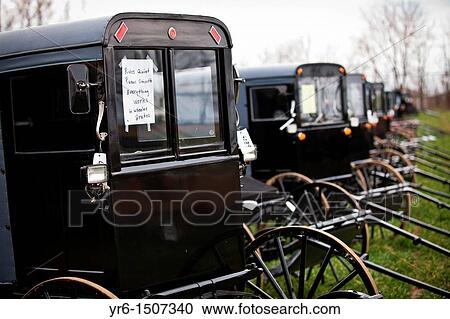 Stock Image - Dozens of Amish buggies ready for auction during the Annual Mud Sale to support the Fire Department in Gordonville, PA. Fotosearch