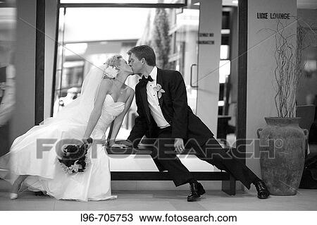 dramatic bride and groom reaching toward each other to kiss View Large Photo Image Stock Image - dramatic bride and groom reaching toward each other to kiss. Fotosearch