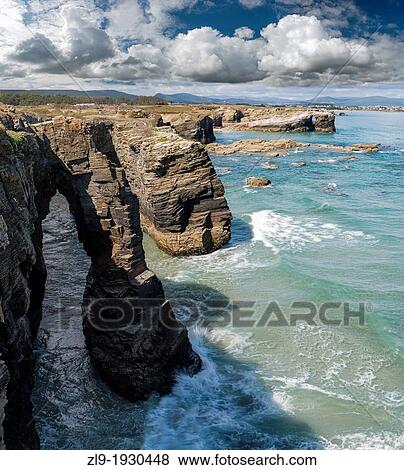Dramatic cliffs at Playa Catedrales, Galicia coast, Spain View Large Photo Image Stock Photo - Dramatic cliffs at Playa Catedrales, Galicia coast, Spain. Fotosearch