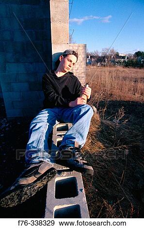 Drepessed adolescent with alcohol View Large Photo Image Stock Photo - Drepessed adolescent with alcohol. Fotosearch