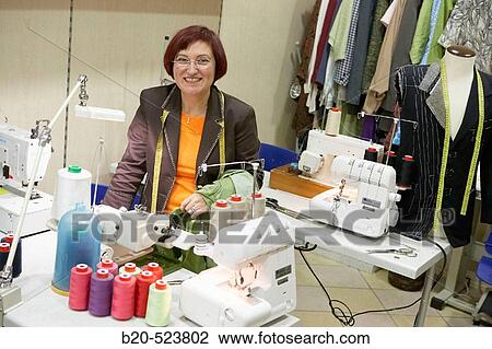 Stock Image - Dressmaking workshop, clothes arrangements. Retail. Elgoibar, Gipuzkoa, Euskadi. Spain.. Fotosearch