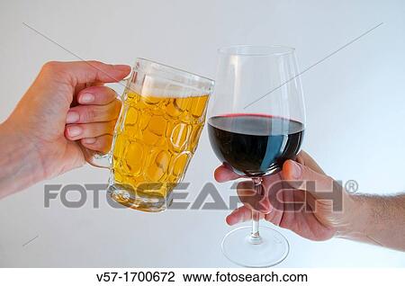 Drinking a toast with beer and red wine Close view View Large Photo Image Stock Image - Drinking a toast with beer and red wine Close view. Fotosearch