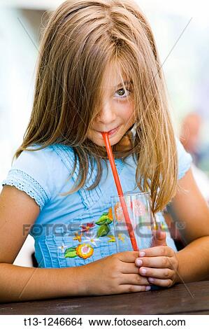 Picture - Drinking from an empty glass young girl. Fotosearch