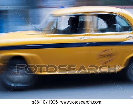 Driver in a taxicab in Calcutta, West Bengal, India View Large Photo Image Stock Photograph - Driver in a taxicab in Calcutta, West Bengal, India. Fotosearch