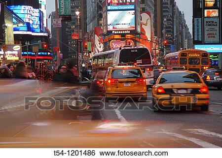Driving yellow Cabs in the Evening at Times Square in New York View Large Photo Image Stock Photograph - Driving yellow Cabs in the Evening at Times Square in New York. Fotosearch