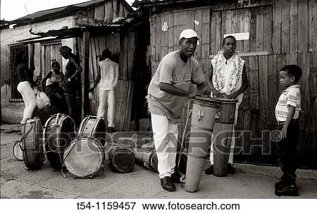 Drumming People in a suburb of Santiago de Cuba View Large Photo Image Stock Photo - Drumming People in a suburb of Santiago de Cuba. Fotosearch