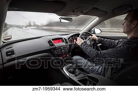 Drving fast down a motorway in the rain from inside the car. View Large Photo Image Picture - Drving fast down a motorway in the rain from inside the car.. Fotosearch