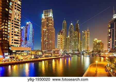 Stock Image - Dubai Marina by night, modern skyscrapers on the canal, Dubai, United Arab Emirates. Fotosearch