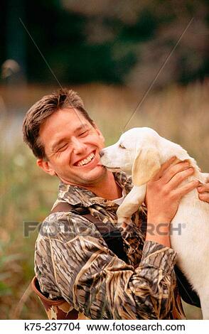 Picture - Duck hunter and his new lab pup. Fotosearch