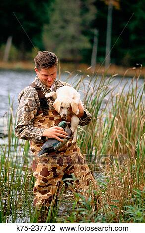 Duck hunter training new pup View Large Photo Image Stock Image - Duck hunter training new pup. Fotosearch