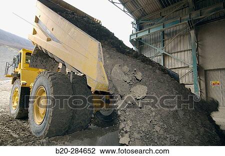 Stock Image - Dumper-truck unloading marl at quarry, cement plant. Fotosearch