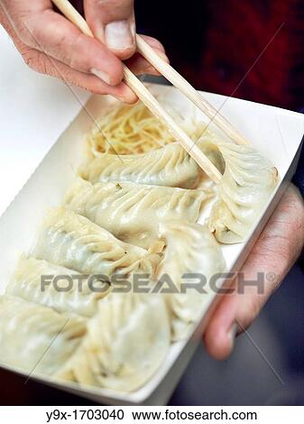 Dumplings, a traditional Chinese delicacy, being prepared by a street vendor in Yong Kang Jie, Taipei, Taiwan View Large Photo Image Stock Image - Dumplings, a traditional Chinese delicacy, being prepared by a street vendor in Yong Kang Jie, Taipei, Taiwan. Fotosearch