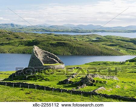 Stock Image - Dun Carloway Broch (Doune Carlabhagh) dating back to the Iron Age, a landmark of the Isle of Lewis. Europe, Scotland, June.. Fotosearch