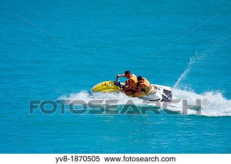 Duo jet skiing in tropical waters View Large Photo Image Stock Photography - Duo jet skiing in tropical waters. Fotosearch