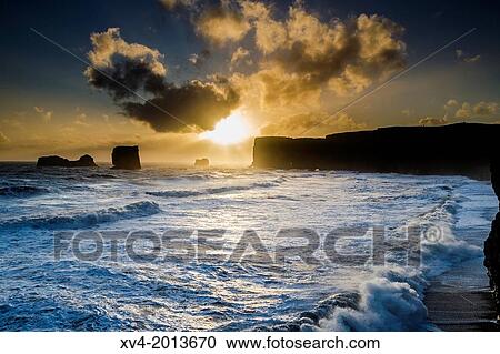 Dyrholaey coastline at sunset. Southern Iceland. View Large Photo Image Stock Image - Dyrholaey coastline at sunset. Southern Iceland.. Fotosearch