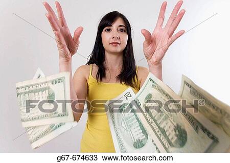 Early 20s brunette cauicasian woman throws money, USD twenty dollar bills, towards camera View Large Photo Image Stock Image - Early 20s brunette cauicasian woman throws money, USD twenty dollar bills, towards camera. Fotosearch