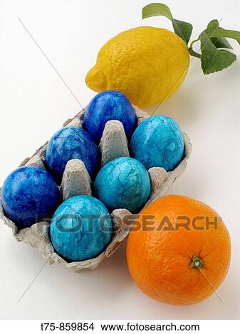 Picture - Easter eggs colored with orange and lemon. Fotosearch