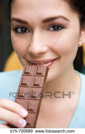 Stock Photo - eating a chocolate bar. Fotosearch