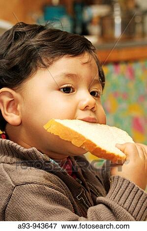 Eating a piece of bread. View Large Photo Image Stock Photo - Eating a piece of bread.. Fotosearch