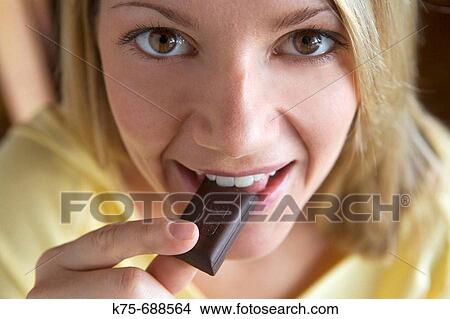 Picture - Eating chocolate. Fotosearch