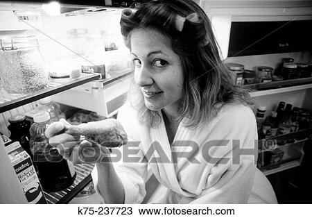 Stock Image - eating out of the refrigerator. Fotosearch