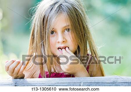 Eating tiny strawberry View Large Photo Image Stock Image - Eating tiny strawberry. Fotosearch
