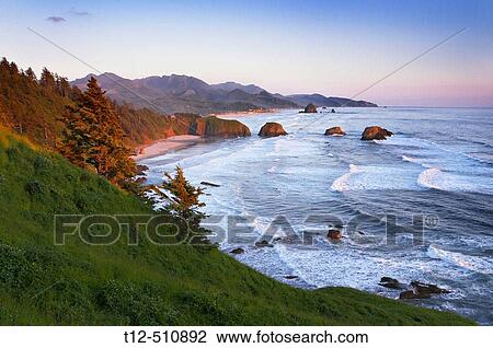 Stock Image - Ecola State Park overlooking Canon Beach, Oregon, at sunset.. Fotosearch