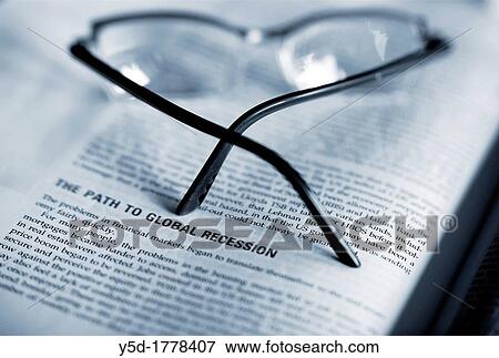 economy handbook, science book about global recession, with glasses on out of focus View Large Photo Image Stock Photo - economy handbook, science book about global recession, with glasses on out of focus. Fotosearch