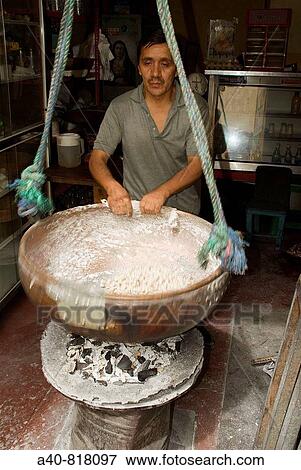 Stock Photo - Ecuador. Quito. Traditional sweets. Craftsman making peanuts garrapiadas.. Fotosearch