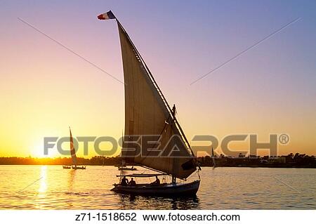 Egypt, Aswan, sunset on the Nile river, feluccas. View Large Photo Image Stock Image - Egypt, Aswan, sunset on the Nile river, feluccas.. Fotosearch