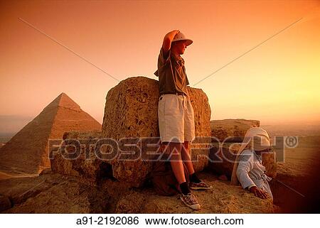 Stock Photograph - EGYPT. CAIRO. GIZEH. MISS PEGGY HECKENWORTH ON TOP OF MYKERINOS PYRAMID AFTER CLIMBING AT NIGHT.. Fotosearch