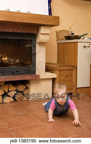Eight-Month baby crawling by the fireplace in the kitchen View Large Photo Image Stock Image - Eight-Month baby crawling by the fireplace in the kitchen. Fotosearch