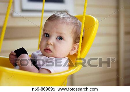 Eight month old baby in swing View Large Photo Image Stock Photography - Eight month old baby in swing. Fotosearch