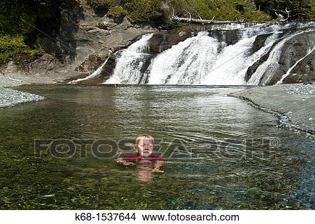 Picture - eight year old boy at Calvin Falls, Nootka Island, BC, Canada. Fotosearch