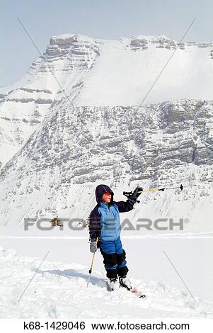 Stock Photograph - eight year old boy skis in Banff National Park, Alberta, Canada. Fotosearch