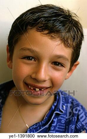 Stock Image - Eight year old boy smiling to reveal missing teeth. Fotosearch