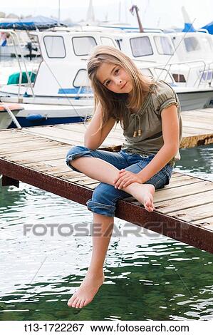 Eight year old girl in a small harbor View Large Photo Image Stock Photo - Eight year old girl in a small harbor. Fotosearch