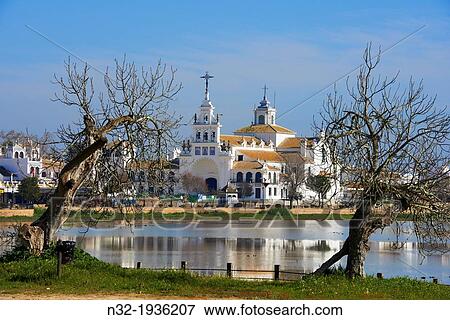 El Rocio village and Hermitage, Almonte El Rocio, El Rocio Marismas de Doana, Doana National Park, Huelva province, Andalusia Spain View Large Photo Image Stock Photo - El Rocio village and Hermitage, Almonte El Rocio, El Rocio Marismas de Doana, Doana National Park, Huelva province, Andalusia Spain. Fotosearch