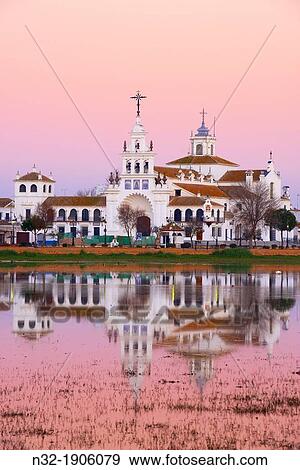 El Rocio village and Hermitage at Sunset, Almonte El Rocio, El Roc? o Marismas de Doana, Doana National Park, Huelva province, Andalusia Spain View Large Photo Image Stock Photo - El Rocio village and Hermitage at Sunset, Almonte El Rocio, El Roc? o Marismas de Doana, Doana National Park, Huelva province, Andalusia Spain. Fotosearch