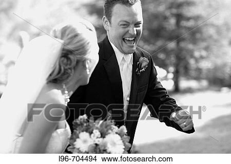 elated groom stealing away with his bride after the wedding ceremony View Large Photo Image Picture - elated groom stealing away with his bride after the wedding ceremony. Fotosearch
