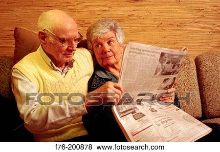 Elder couple reading newspaper View Large Photo Image Stock Photo - Elder couple reading newspaper. Fotosearch