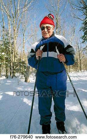 Stock Image - Elder man cross-country skiing. Lancaster. New Hampshire. USA. Fotosearch