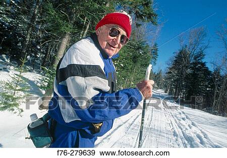 Stock Photo - Elder man cross-country skiing. Lancaster. New Hampshire. USA. Fotosearch