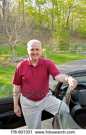 Elder retired man standing by car. View Large Photo Image Stock Image - Elder retired man standing by car.. Fotosearch