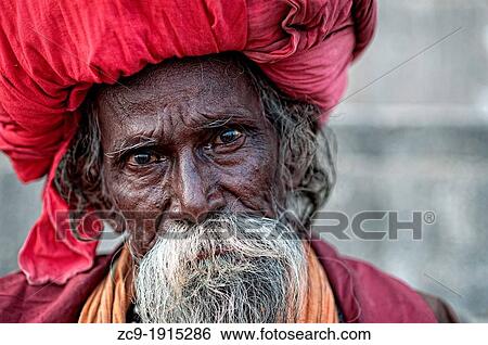 Stock Photograph - Elder shadu wearing a big turban Varanasi, Benares, Uttar Pradesh, India. Fotosearch