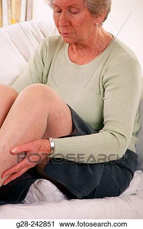 Stock Image - Elder woman showing her legs.. Fotosearch