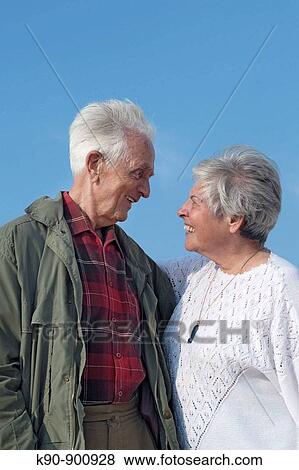 Elderly caucasian couple looking and laughing at each other, Island of Amrum, Northfrisian, Schleswig_Holstein, Northern Germany, Europe View Large Photo Image Stock Photo - Elderly caucasian couple looking and laughing at each other, Island of Amrum, Northfrisian, Schleswig_Holstein, Northern Germany, Europe. Fotosearch