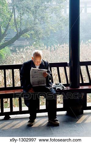 Elderly Chinese man reading newspaper in temple courtyard garden of the Wu Hou Shrine in city of Chengdu, Sichuan Province China View Large Photo Image Stock Photo - Elderly Chinese man reading newspaper in temple courtyard garden of the Wu Hou Shrine in city of Chengdu, Sichuan Province China. Fotosearch