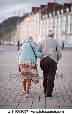 Elderly couple, old man and woman, walking in Aberystwyth promenade, summer evening, Wales UK View Large Photo Image Stock Photo - Elderly couple, old man and woman, walking in Aberystwyth promenade, summer evening, Wales UK. Fotosearch