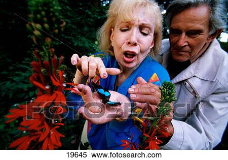 Elderly couple watching butterfly View Large Photo Image Stock Photography - Elderly couple watching butterfly. Fotosearch